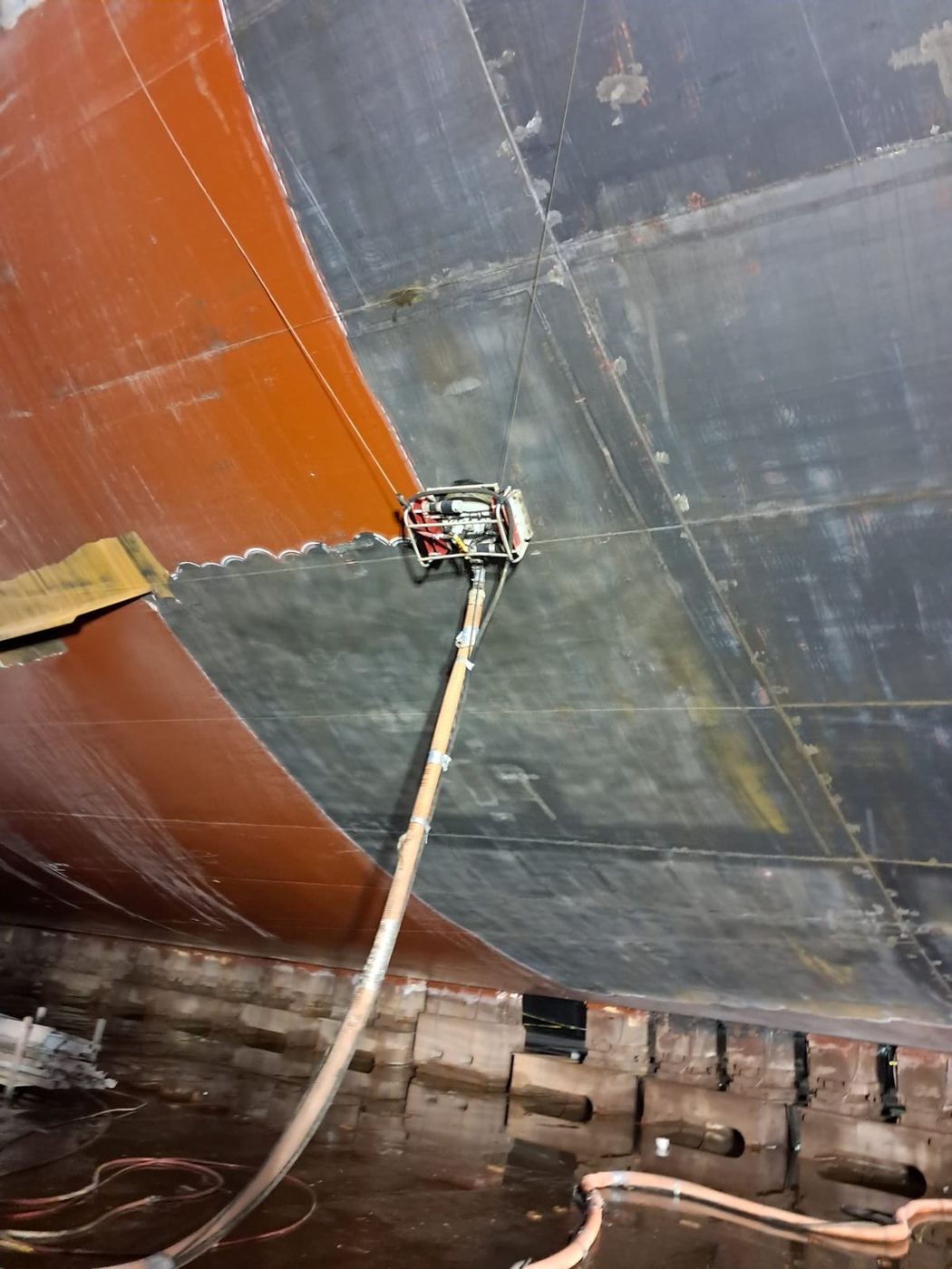 Magnetic UHP crawler on a ship hull in drydock